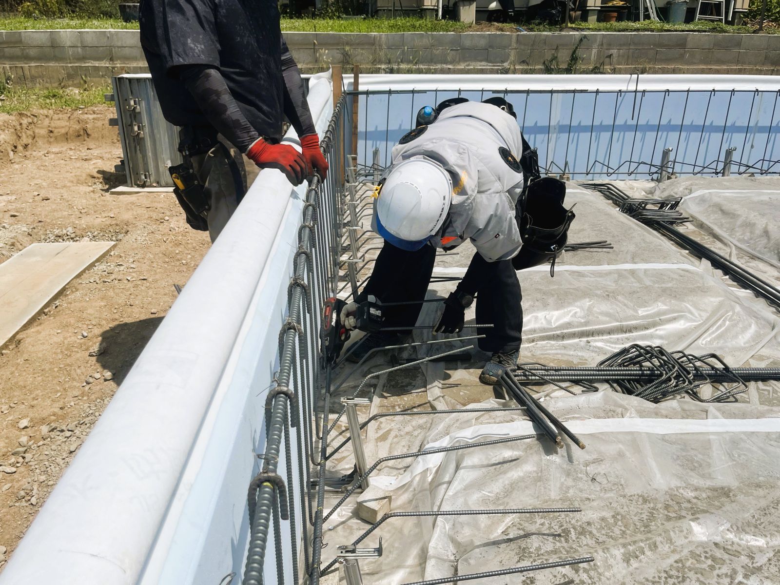 新築住宅の基礎工事で立ち上がり部分の縦筋と主筋を組んでいる様子
